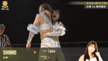 a wrestling match between shinno # 5 and another wrestler