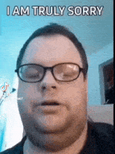 a man wearing glasses and a black shirt is making a funny face .