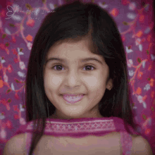 a little girl is smiling in front of a pink background that says " the happy woman "