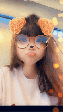 a girl wearing glasses and a teddy bear mask takes a selfie