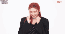 a woman with red hair is smiling and wearing a name tag that says ' statv ' on it