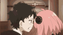 a boy and a girl are standing next to each other and looking at each other .