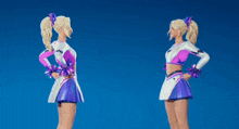 two cheerleaders are giving each other a fist bump against a blue sky