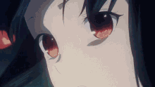 a close up of a girl 's face with red eyes looking at the camera