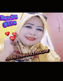 a woman wearing a hijab and sunglasses is smiling with the words " assalamualaikum " on the bottom right
