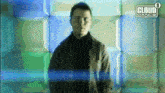 a man stands in front of a cloud 9 dance sign