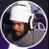a man with a beard is wearing headphones and a helmet .