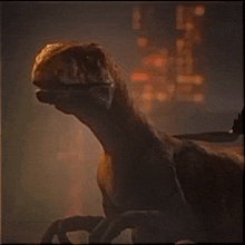 a close up of a dinosaur with a person standing behind it