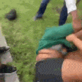 a man in a green shirt is being held by another man