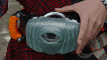 a close up of a person 's hand holding a toy