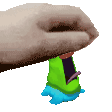 a hand is holding a green object that looks like a toy .