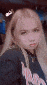 a girl taking a selfie with a sticker that says ' sos ' on it