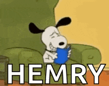 snoopy is sitting in a chair reading a book and holding a blue cup .
