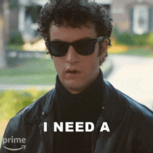 a man wearing sunglasses and a black leather jacket says i need a