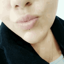 a close up of a woman 's lips with a lip piercing