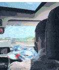 a man driving a car with a sunroof that has a warning on it