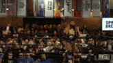 a wrestler in a ring with a sign that says gell on it