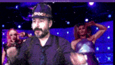 a man with a beard wearing a hat with the word shark on it