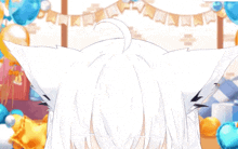 a girl with white hair and blue eyes is wearing a cat ears headband .