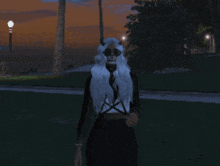 a woman with horns on her head stands in a park at night