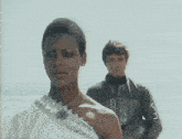 a man and a woman standing on a beach
