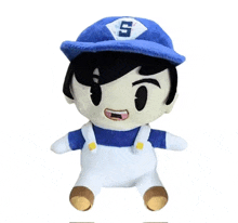 a stuffed toy of a man wearing a blue hat and overalls .