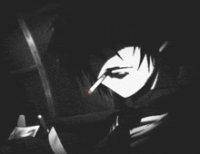 a man is smoking a cigarette in the dark