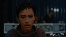 a close up of a woman 's face with the hashtag uploadtv on the bottom