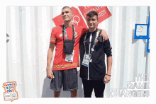 two athletes are posing for a picture with the words the game changers behind them