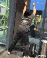 a man wearing a shirt that says ' sd ' on the back is standing in a doorway