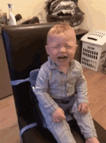 a baby is sitting in a high chair and crying