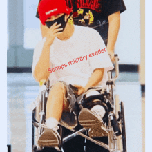 a person in a wheelchair with the words " scoups military evader " on it
