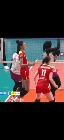 a volleyball player with the number 11 on their jersey