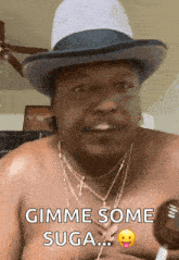 a shirtless man is wearing a hat and necklaces and says gimme some suga