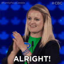 a woman applauds while wearing a green shirt that says " elle "