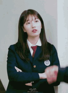 a girl in a school uniform with a badge that says ' pccapture941010 '