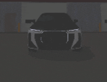 a black car is parked in a dark garage with the headlights on