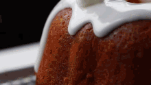 a close up of a bundt cake with white frosting