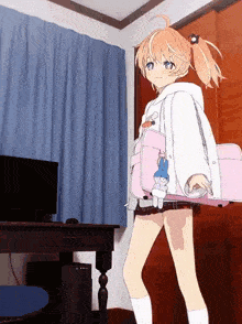 a girl is holding a pink bag in a room with a computer in the background