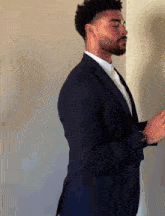 a man in a suit is standing in a room