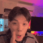 a young man wearing headphones is making a funny face in a living room
