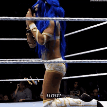 a woman in a wrestling ring says " i lost " in front of a crowd