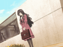 a girl in a pink dress holding a briefcase