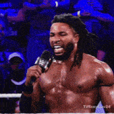 a shirtless wrestler is talking into a microphone with the hashtag tiffanyluv24