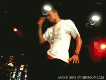 a man playing a guitar on a stage with the words make gifs at gifsoup.com in the corner
