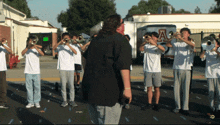 a man stands in front of a band with the letter a on the back of the van