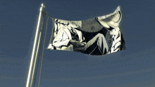 a flag with a picture of a man sitting in front of a clock with the number vi on it