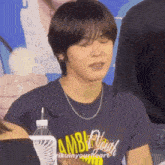 a young man wearing a t-shirt that says ambitious through