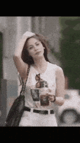 a woman wearing a white shirt that says " i wait for " on it