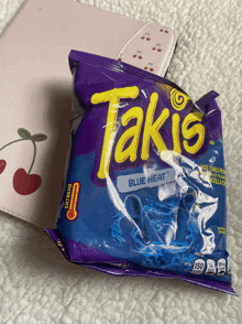 a bag of takis blue heat chips sits on a table